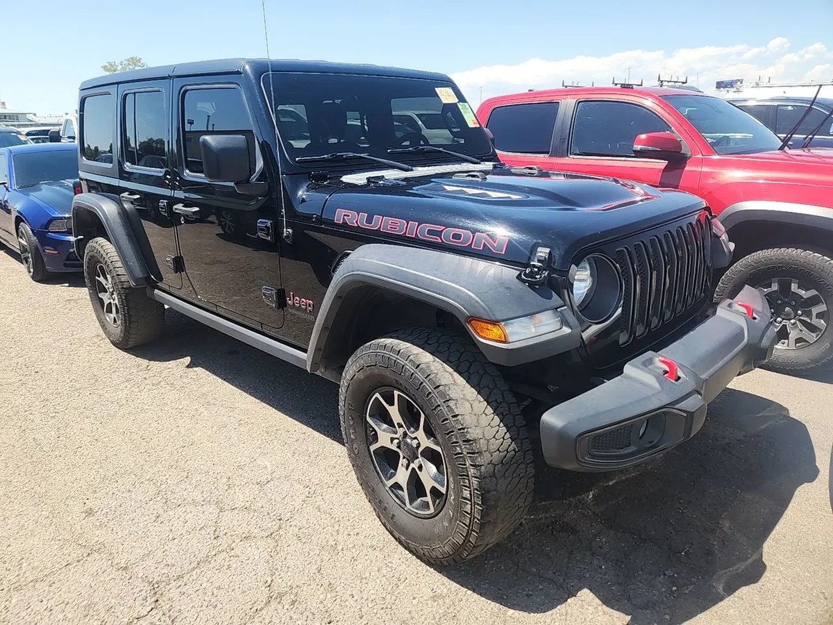 2020 Jeep Wrangler Unlimited Rubicon in black with the Rubicon hood decal and all-terrain tires, front three-quarter view on the auction lot