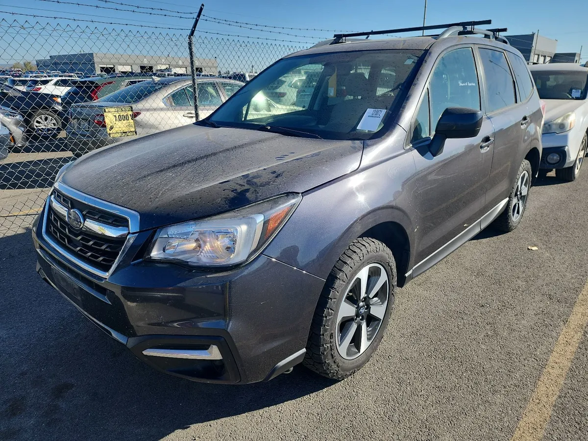2018 Subaru Forester Premium in dark gray with roof rails and crossbars, front three-quarter view on the auction lot