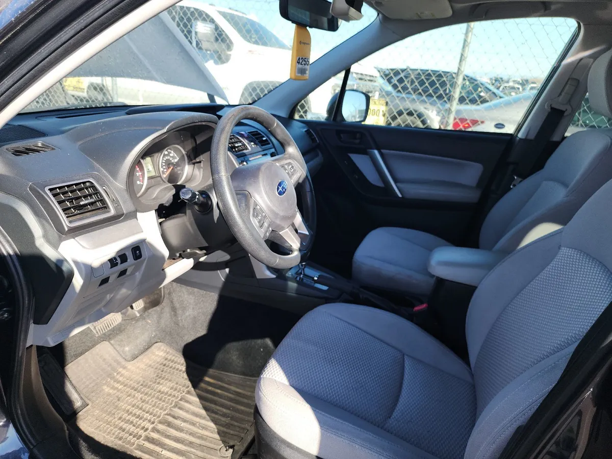 Front seats and dashboard of the 2018 Subaru Forester Premium with light gray cloth seats