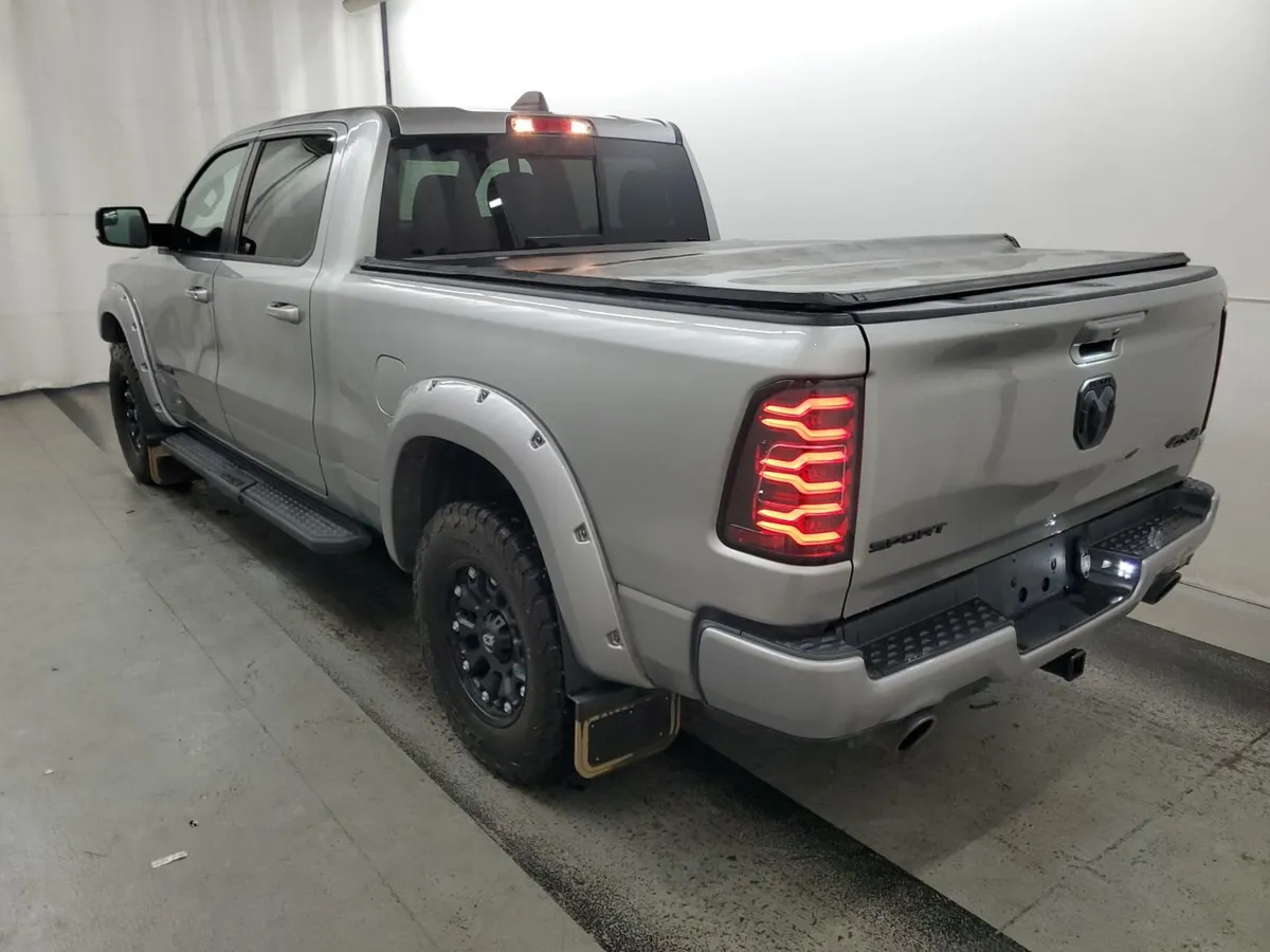 Rear three-quarter view of the 2022 Ram 1500 Sport showing the Sport and 4x4 badges on the tailgate and a folding tonneau cover