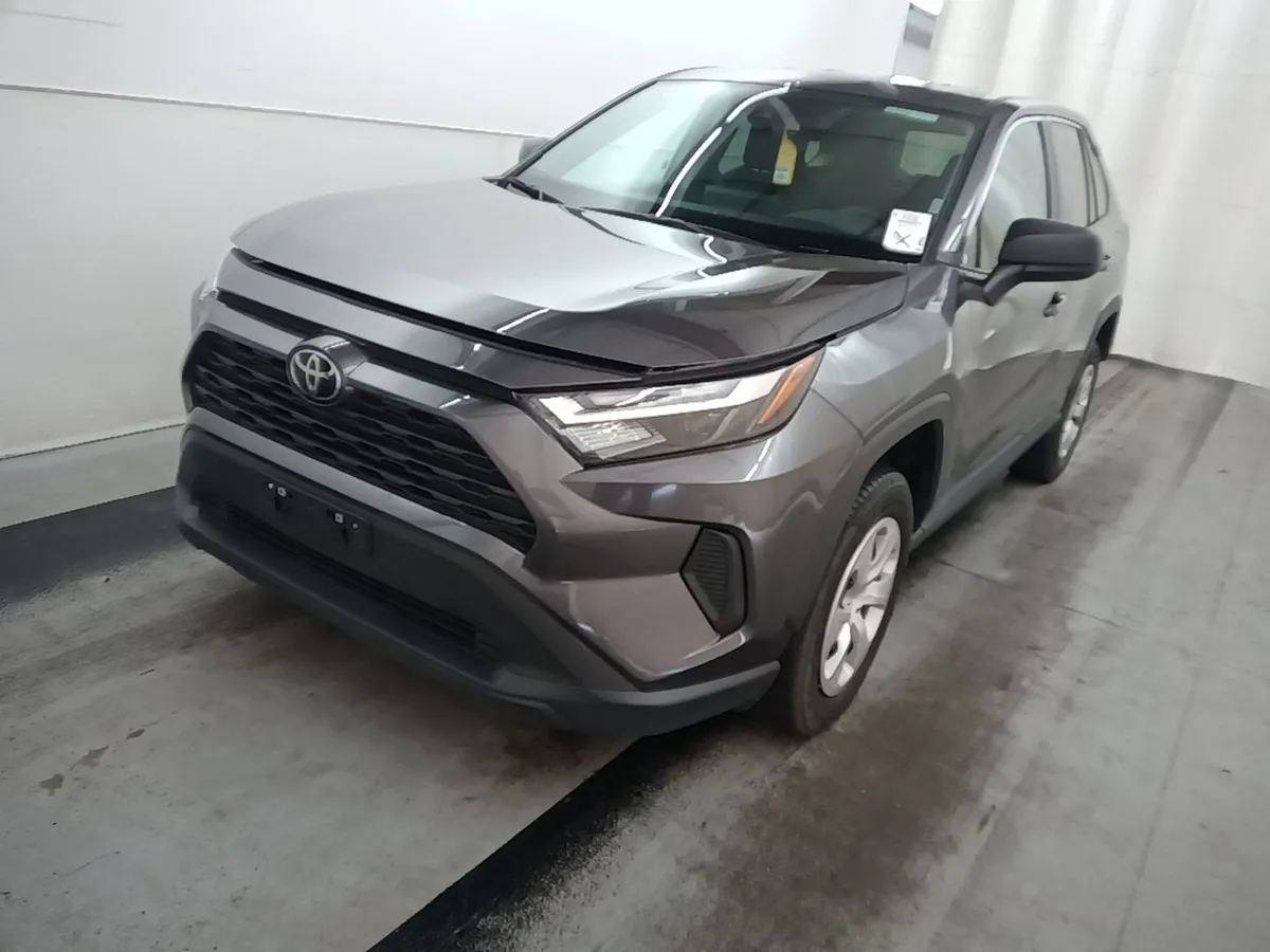 2025 Toyota RAV4 LE in gray, front three-quarter view in the auction photo booth