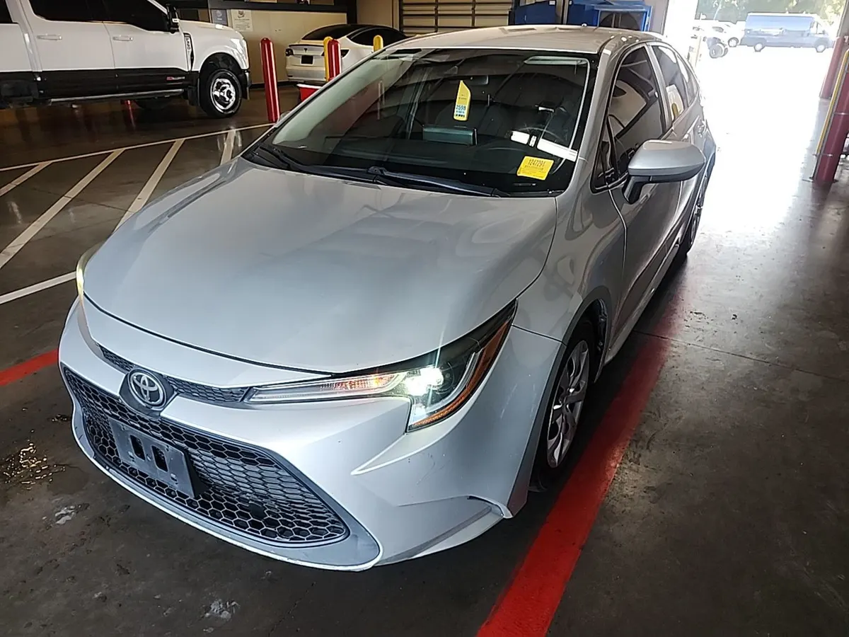 2021 Toyota Corolla LE in silver, front three-quarter view inside the auction building