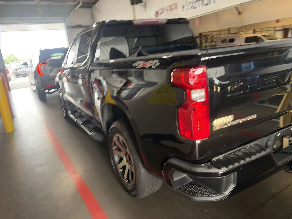 Rear three-quarter view of the 2022 Chevrolet Silverado 1500 Custom showing the 4x4 badge on the bedside