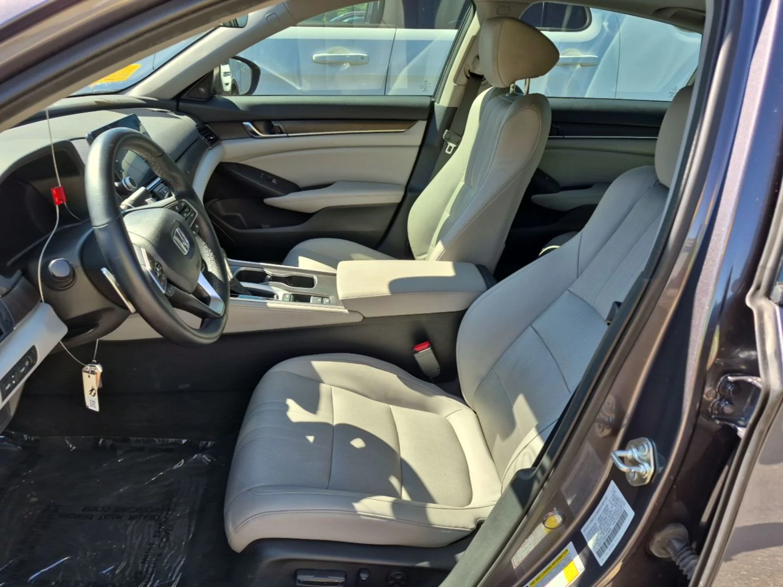 Interior of the 2018 Honda Accord Touring showing two-tone leather seats, digital gauge cluster, and center touchscreen