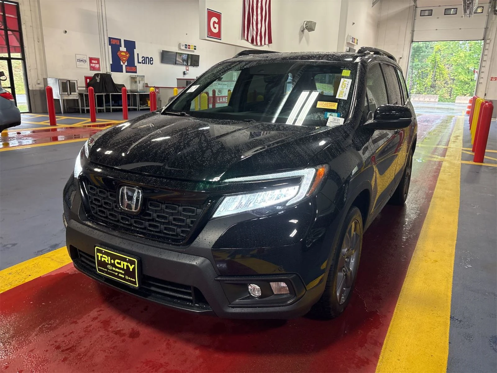 2019 Honda Passport Touring in black, front three-quarter view in the auction lane, like-new condition with body-color and black trim