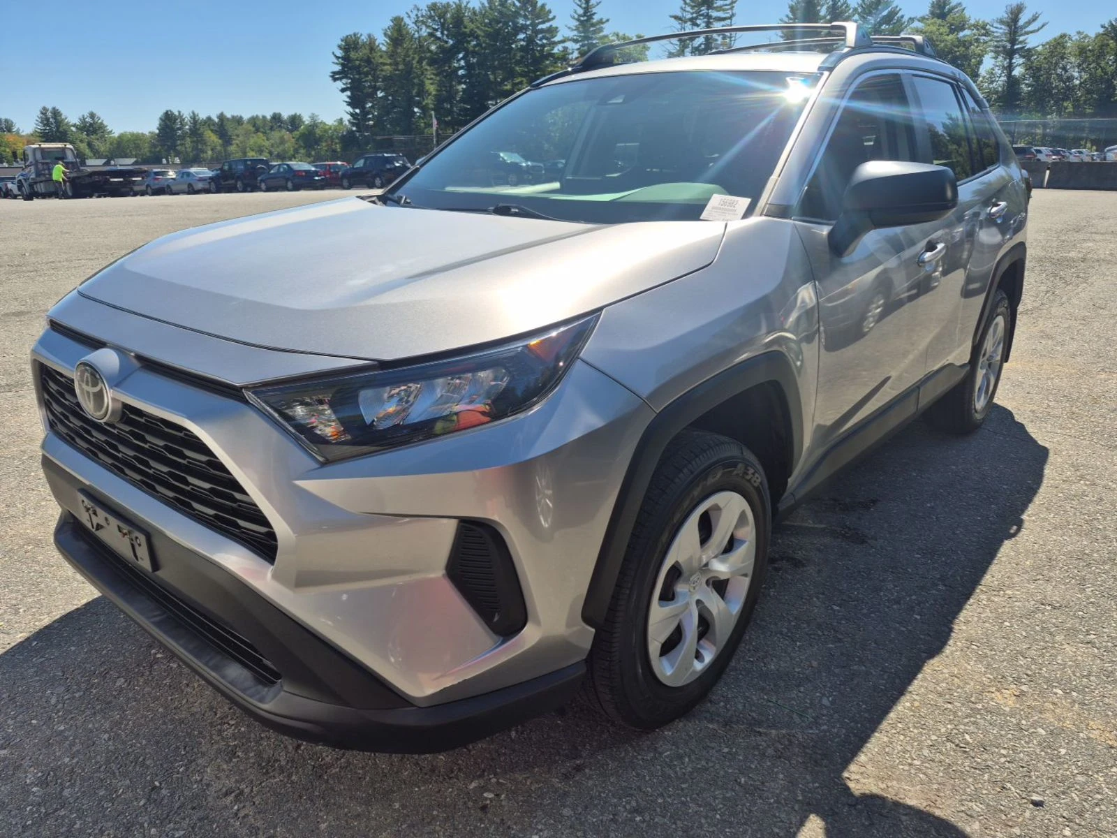 2021 Toyota RAV4 LE in silver, front three-quarter view on the auction lot, clean compact SUV with alloy-look wheels