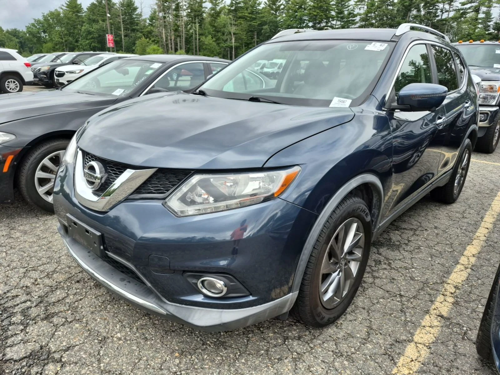 2016 Nissan Rogue SL in dark blue, front three-quarter view on the auction lot, clean body and alloy wheels