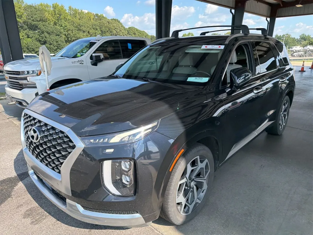 2021 Hyundai Palisade Calligraphy in dark blue that reads almost black, front three-quarter view under the auction canopy