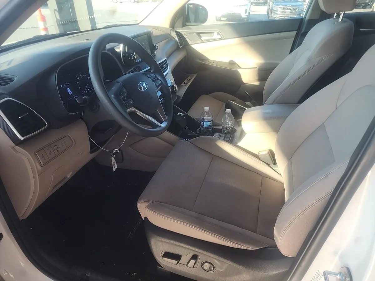 Interior of the 2019 Hyundai Tucson with beige cloth seats and a clean dash