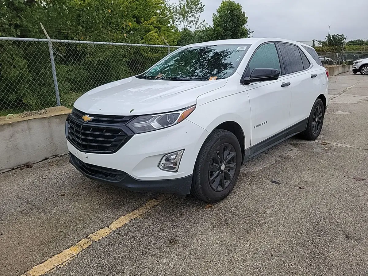 2018 Chevrolet Equinox LT in white with black wheels, front three-quarter view on the auction lot after rain