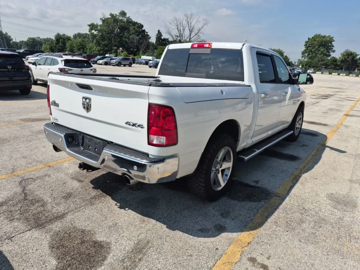 Rear three-quarter view of the 2018 Ram 1500 Big Horn showing the 4x4 and Big Horn badges on the tailgate and a bed cover